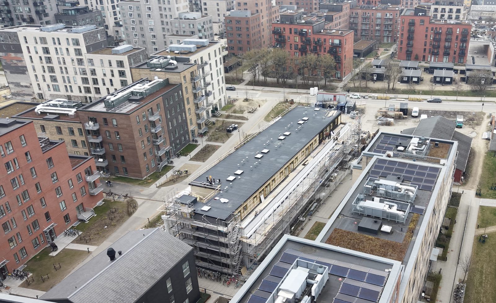 Luftfoto af byggeplads med stillads og nyt tag på Amager