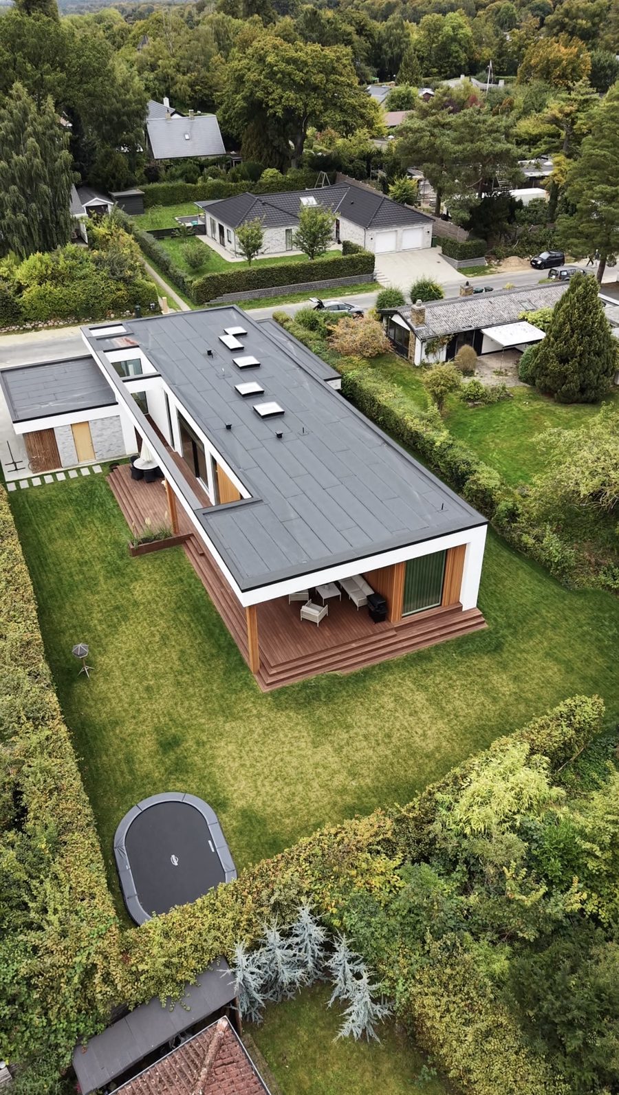 Lodret dronefoto af villa med tagterrasse og have, klar til sociale medier
